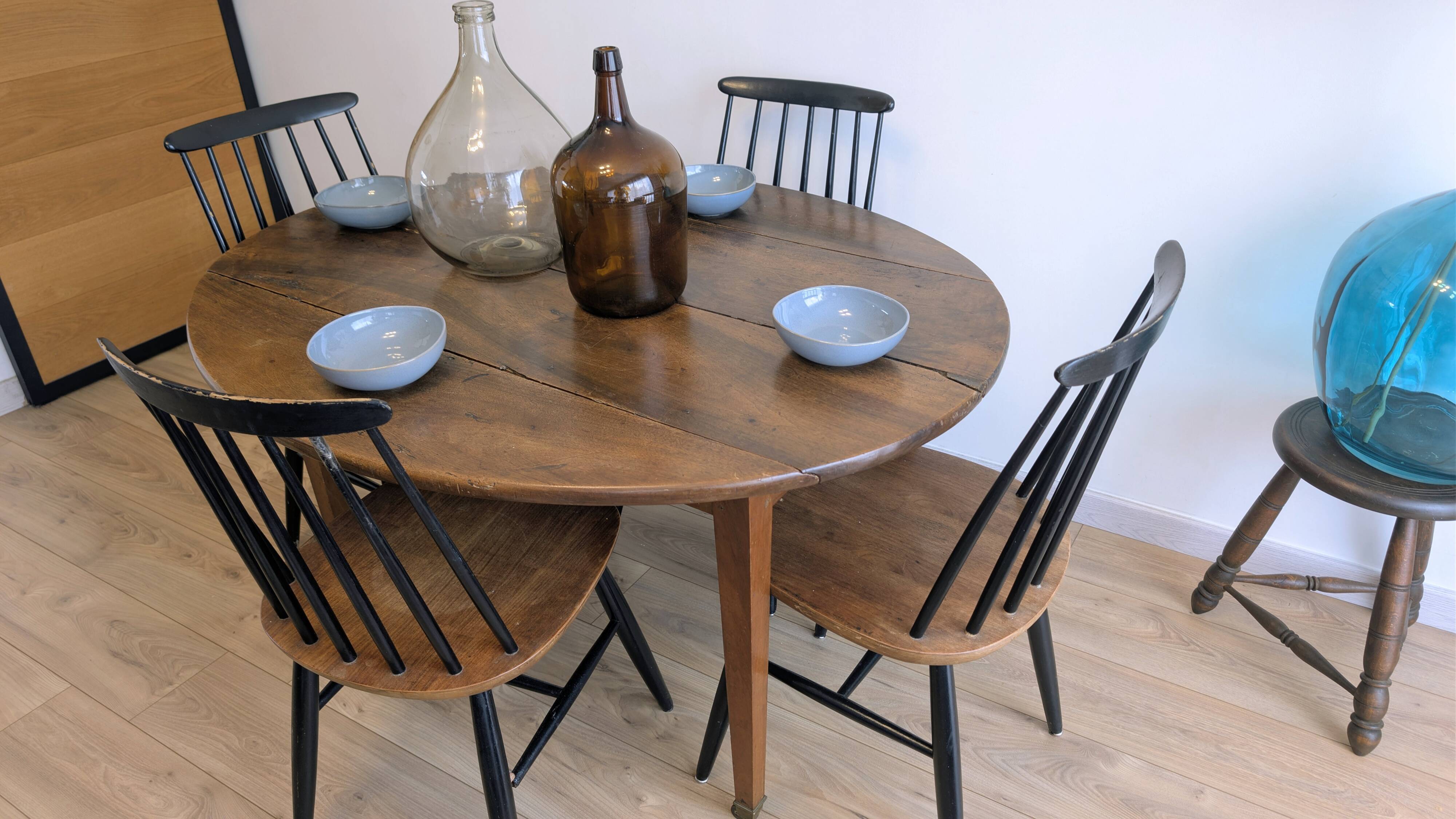Antique wooden folding table with a patina and brass wheels.