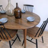 Antique wooden folding table with a patina and brass wheels.