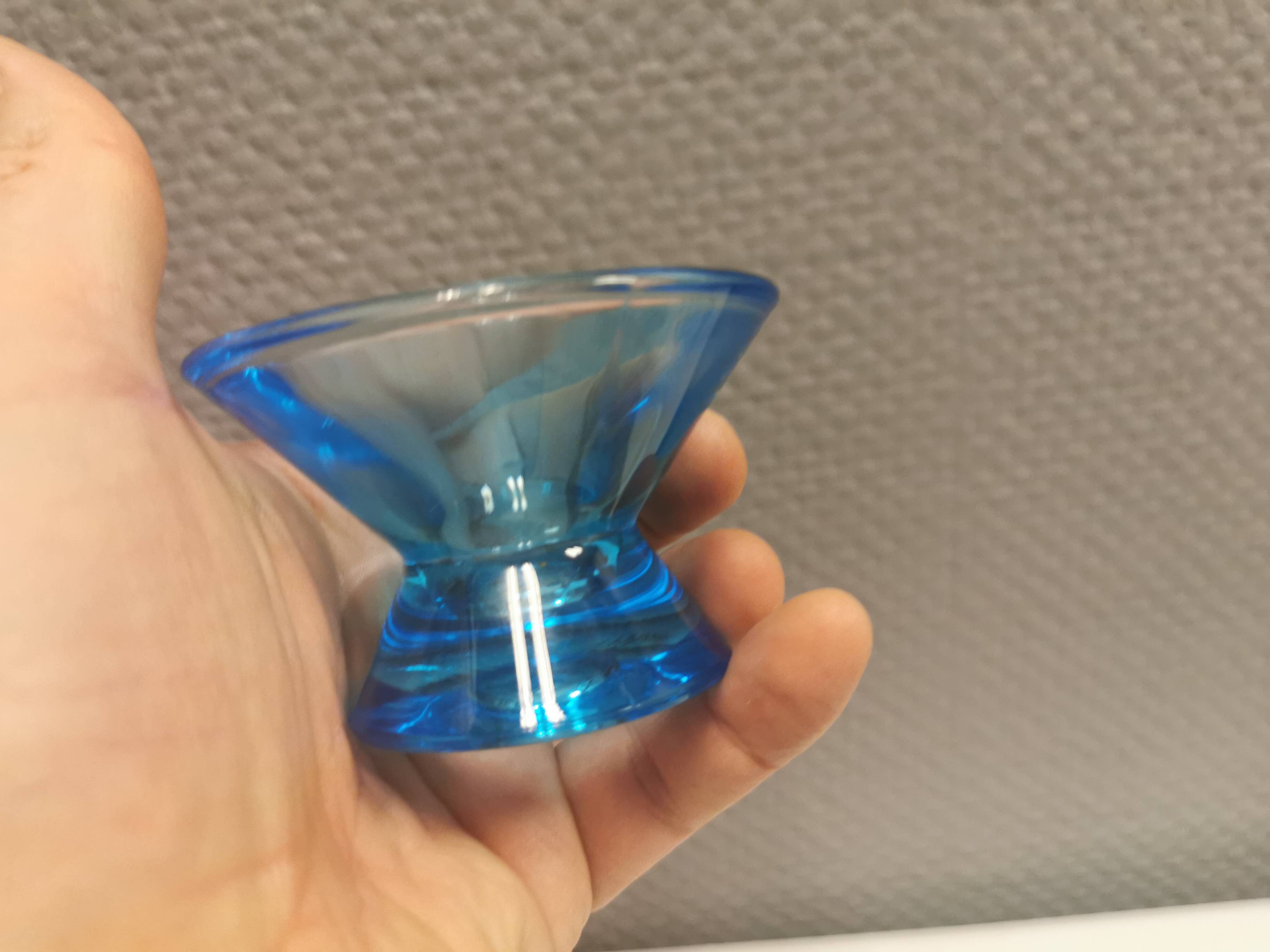 Two small candle holders in blue glass from the well-known Finnish company Ittala.