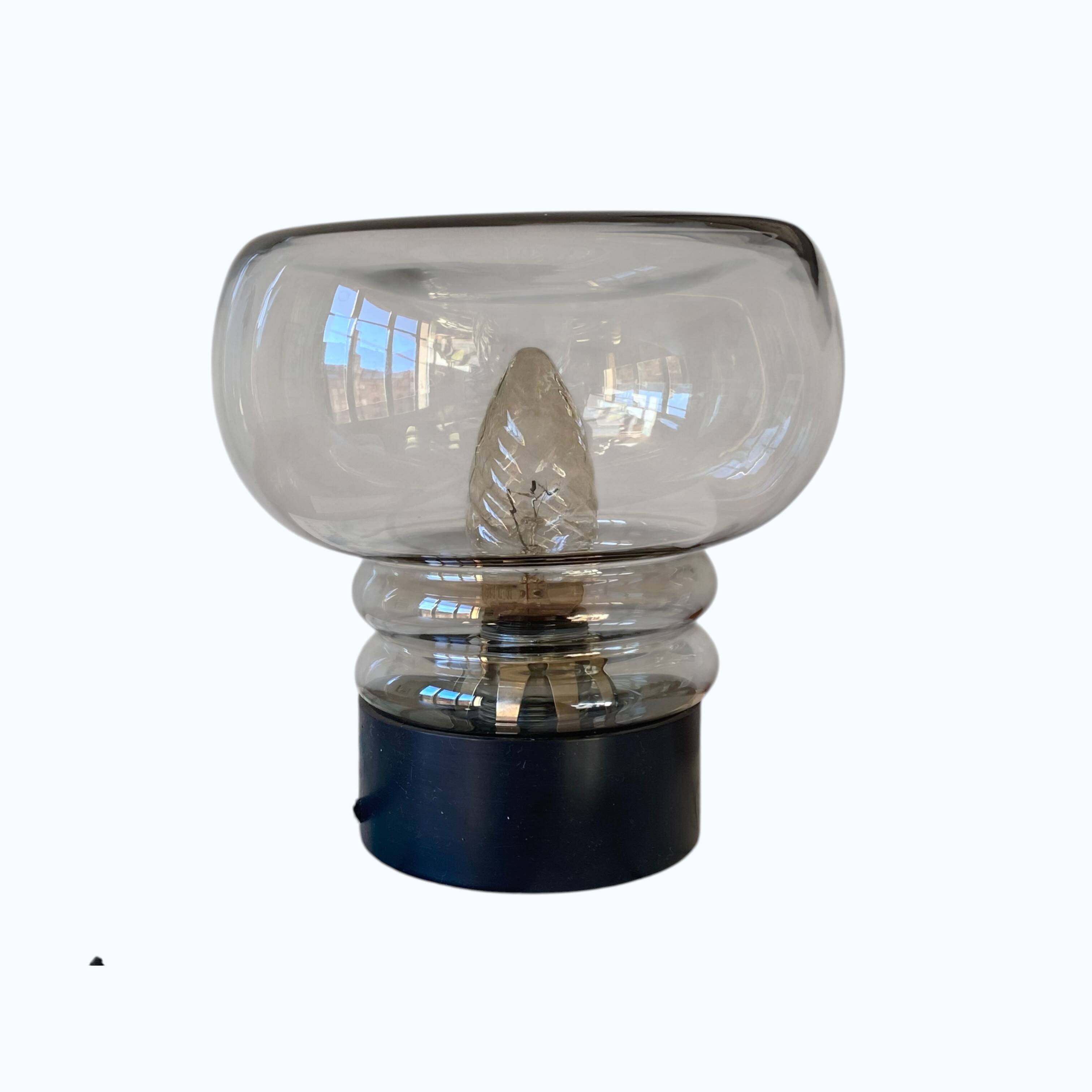 Sciolari table lamp with smoked glass globe and black plastic base.