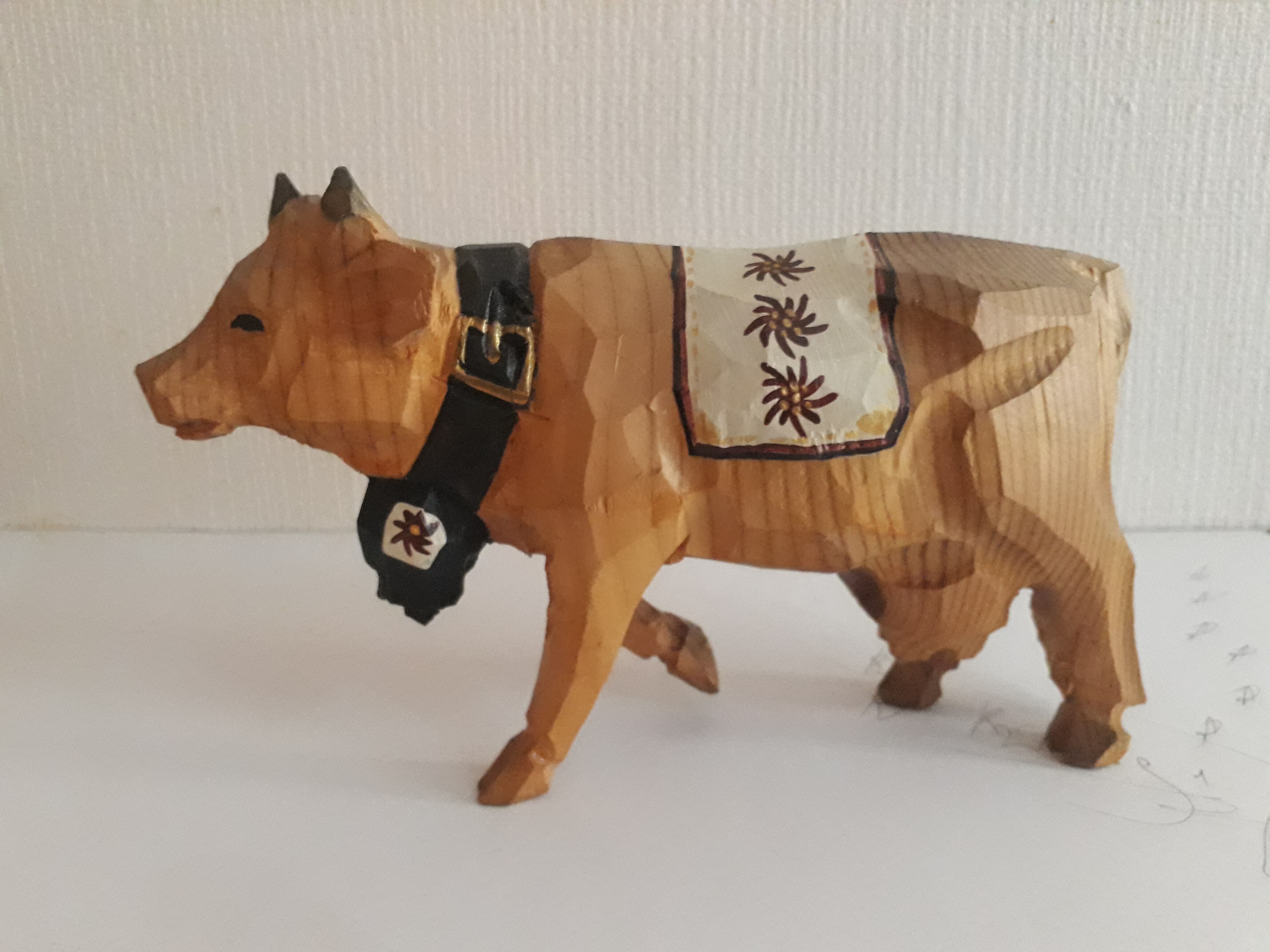 Carved and painted wooden cow