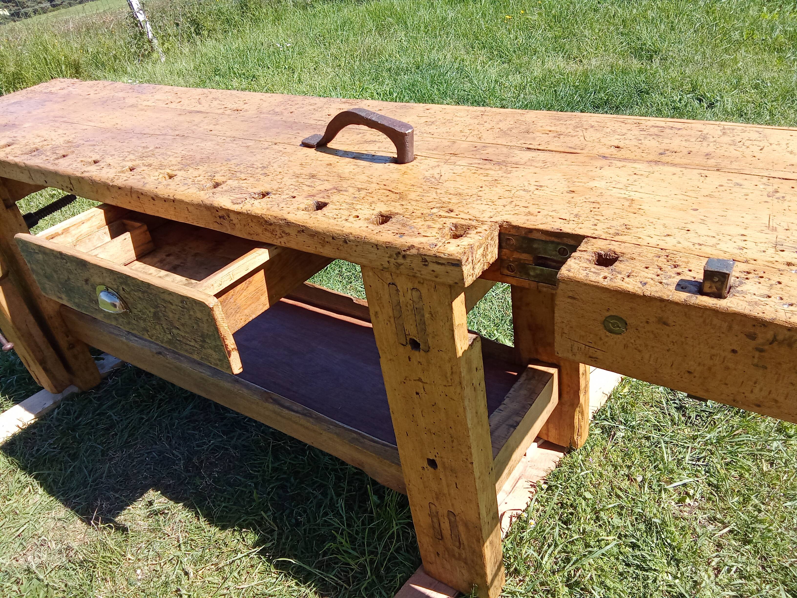 Old solid wood carpenter's bench with 2 functional vices.
