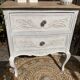Adorable small chest of drawers or weathered white console.