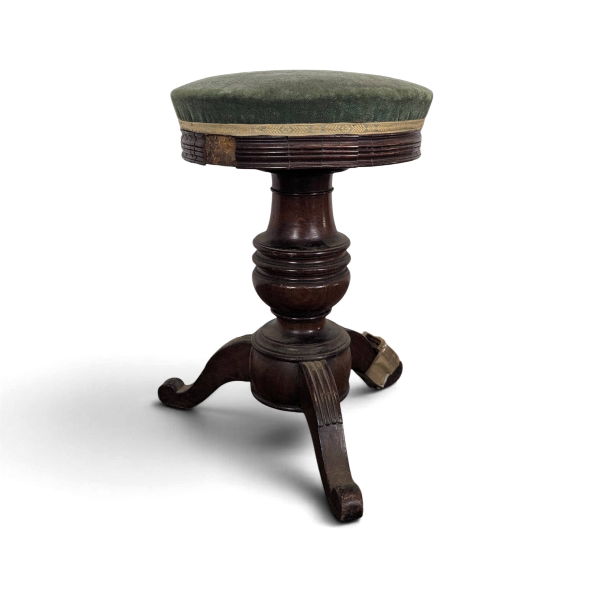 Green velvet piano stool with a turned leg.