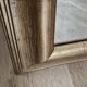 Beveled mirror under gold frame
