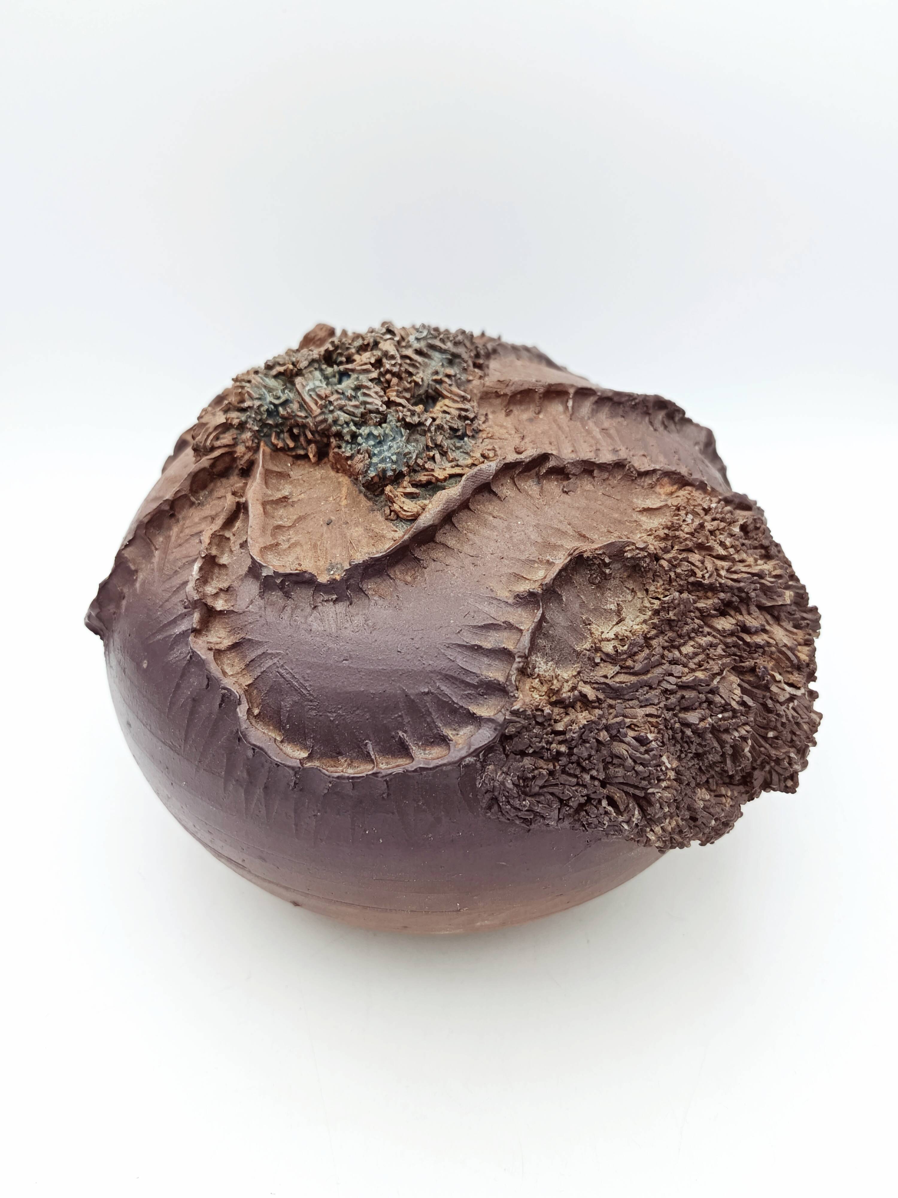 Ceramic vase with organic plant decoration