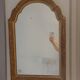Italian mirror with a sculpted patinated arch, neo-Renaissance style.