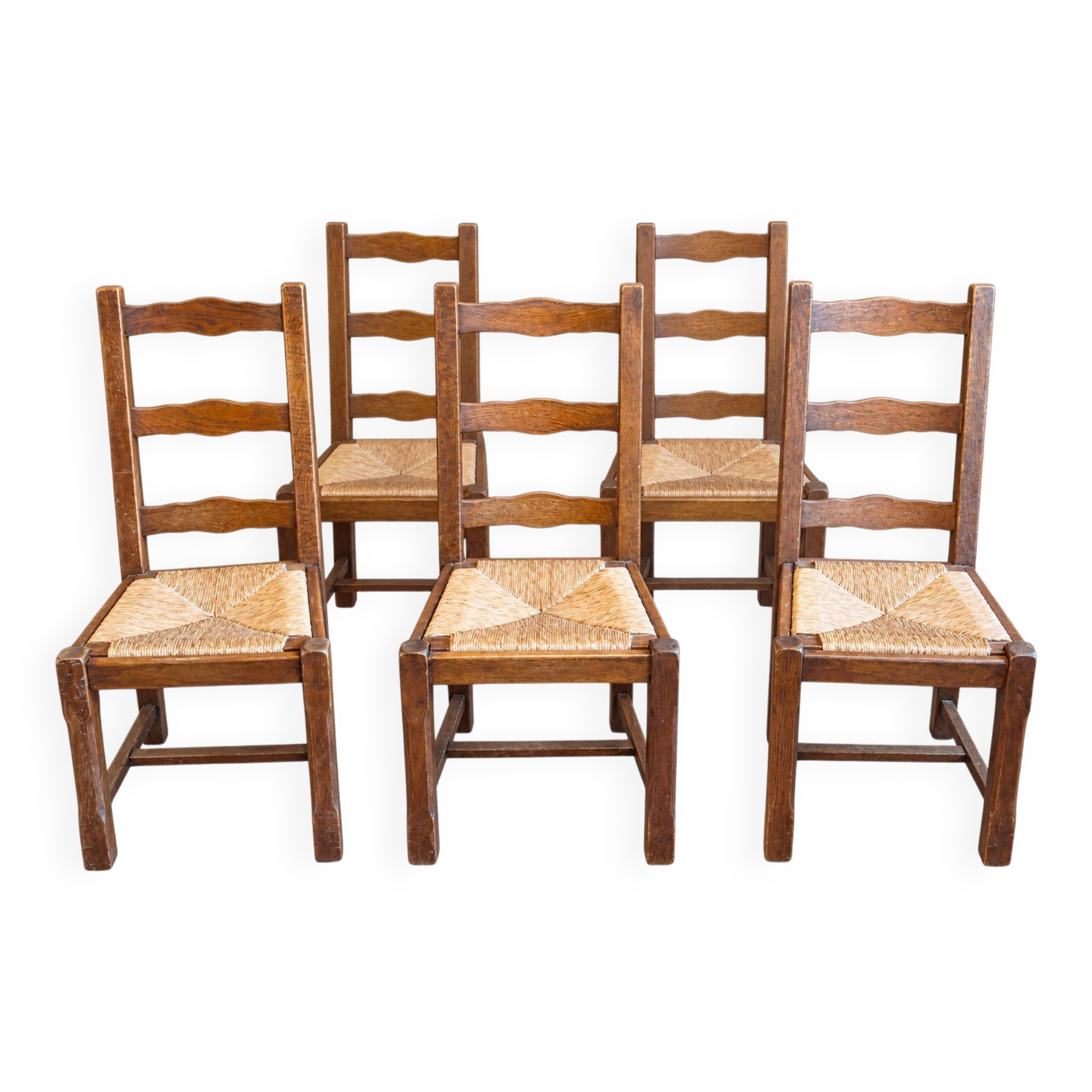 Set of 6 wooden chairs with straw seats and high backs.