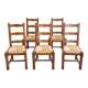 Set of 6 wooden chairs with straw seats and high backs.