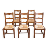 Set of 6 wooden chairs with straw seats and high backs.