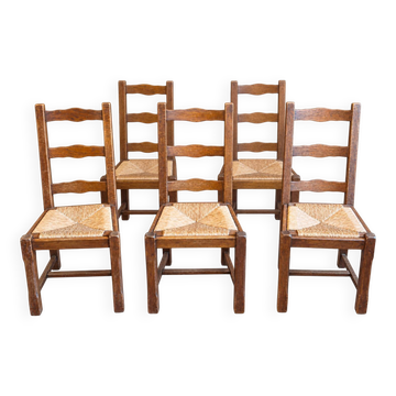Set of 6 wooden chairs with straw seats and high backs.