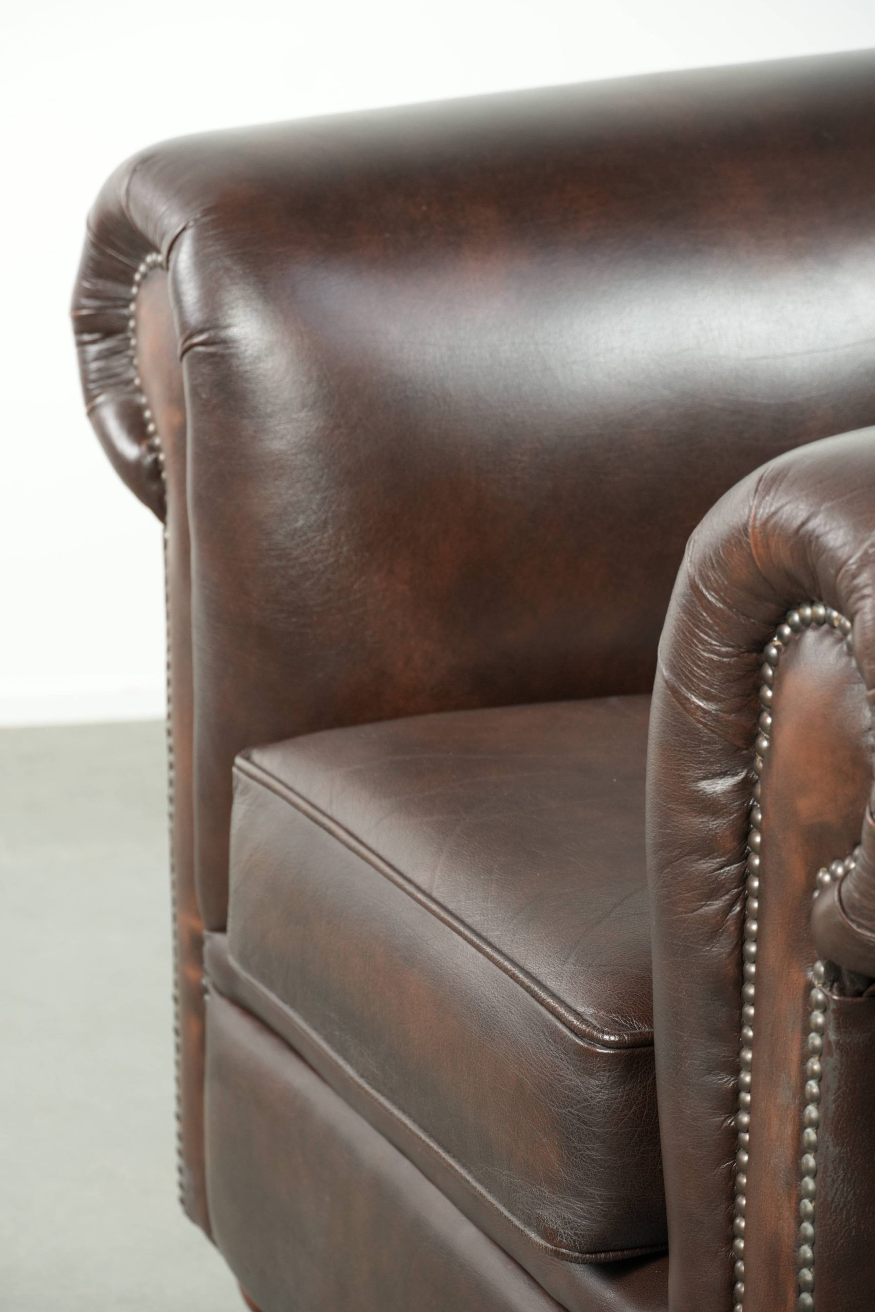 Luxury brown cow leather Chesterfield armchair with a timeless English look