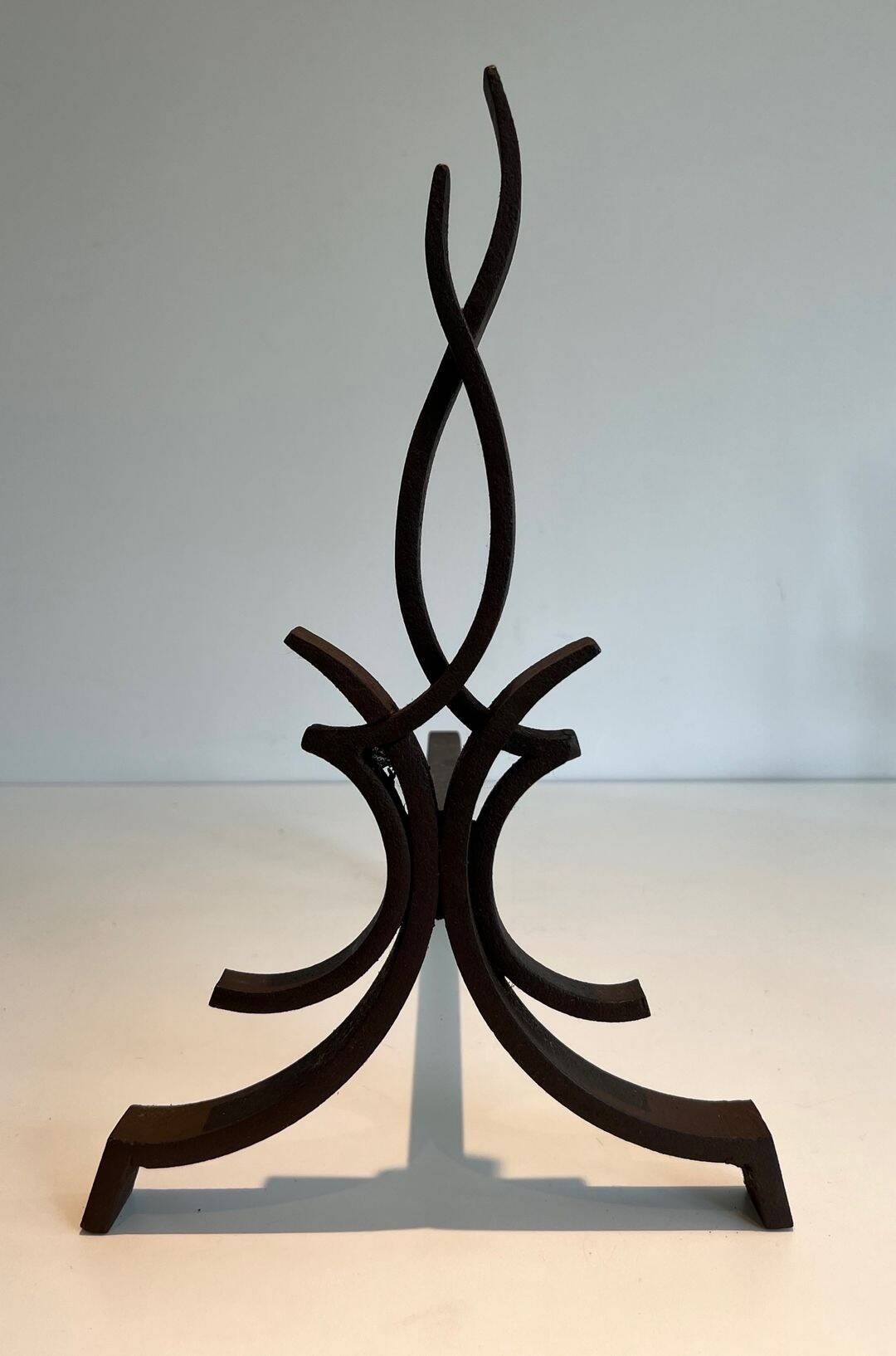 Pair of Wrought Iron Andirons with Stylised Flamboyant Uprights and Enrobed Feet