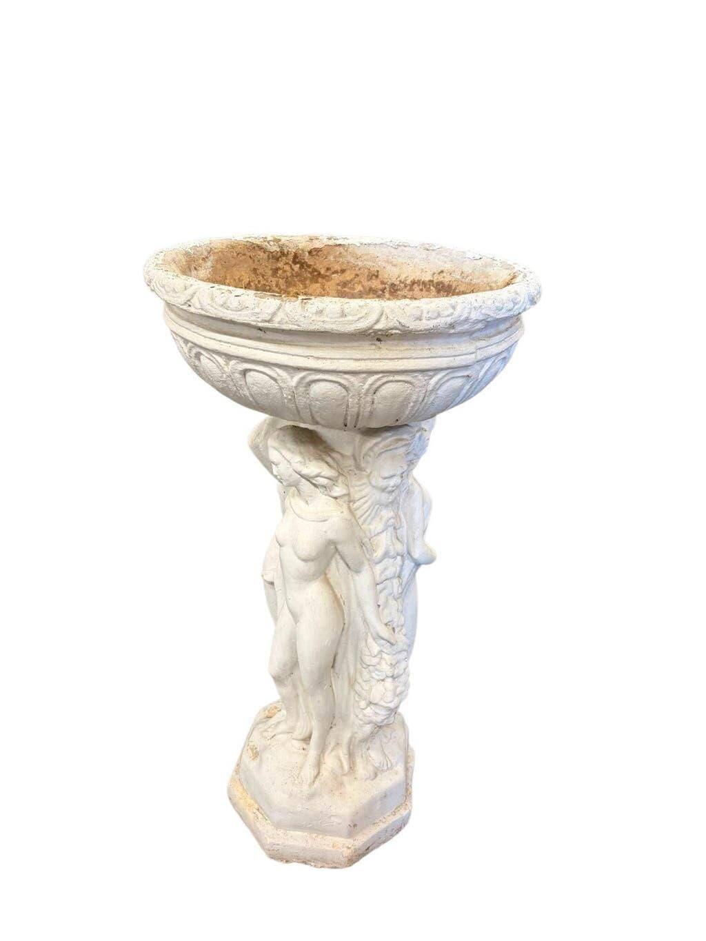 Vintage white concrete garden statue adorned with planter.