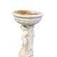 Vintage white concrete garden statue adorned with planter.