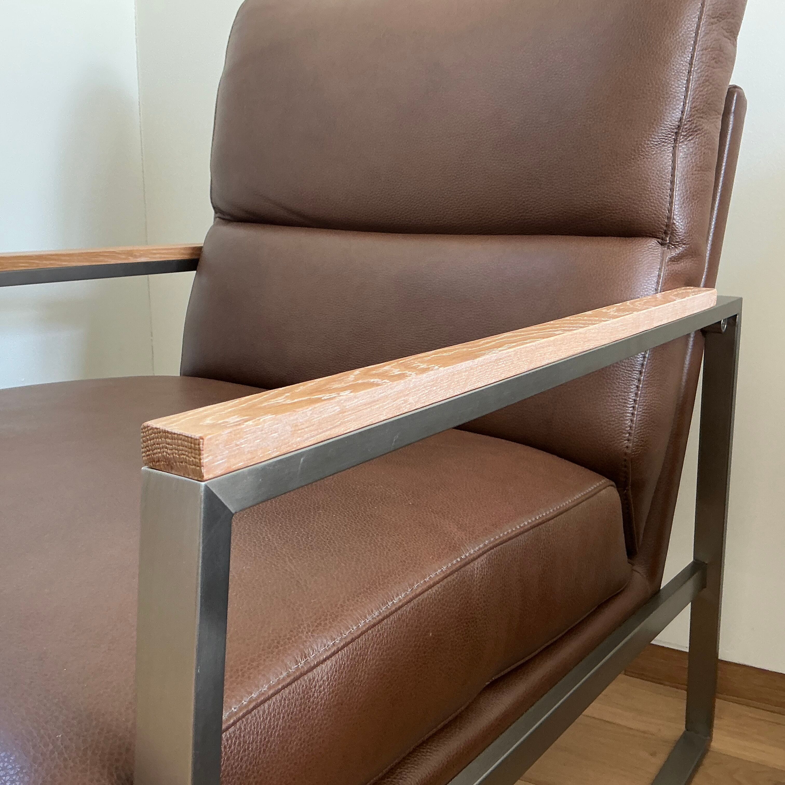 A pair genuine leather armchairs.