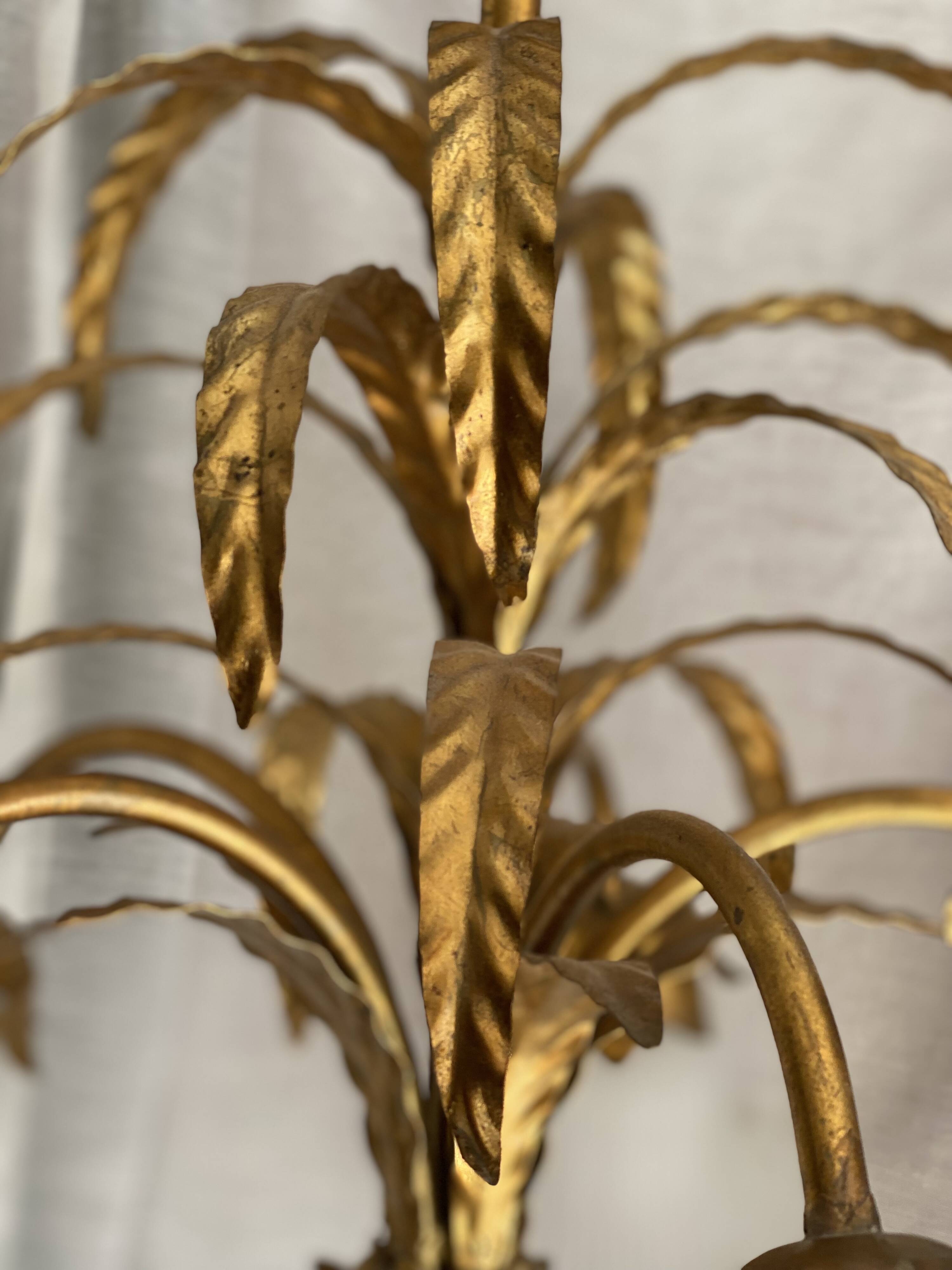 Vintage 1970s golden metal palm chandelier in the style of JANSEN.
