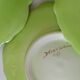 4 hand-decorated earthenware plates with vegetable and green leaf designs.
