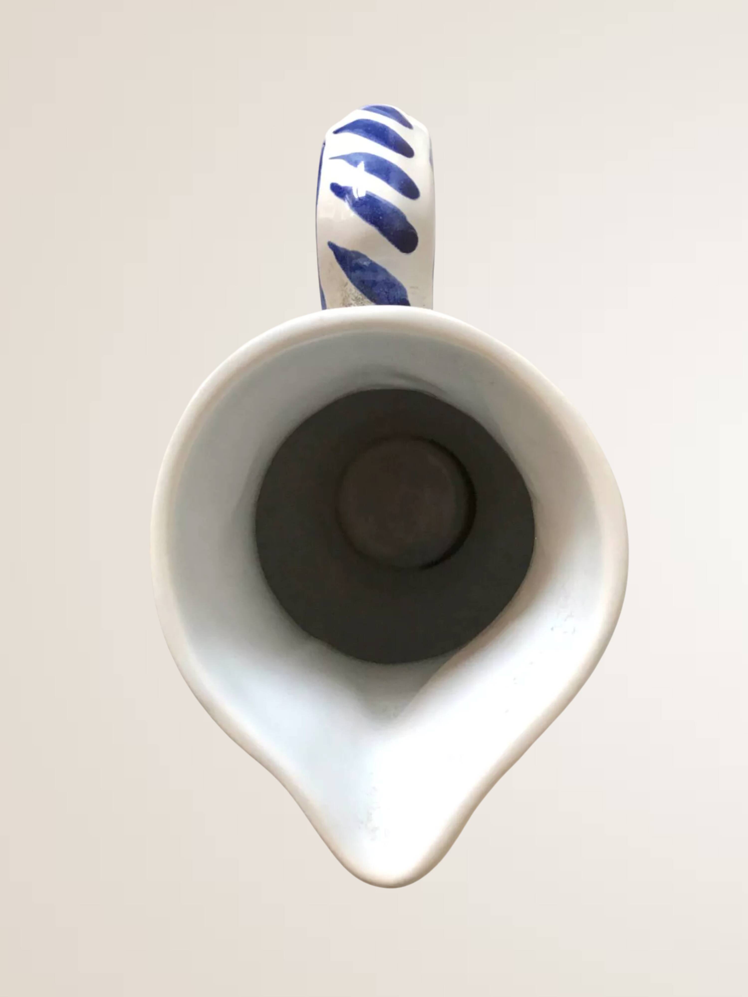 Moutiers earthenware jug, hand-painted blue decoration.