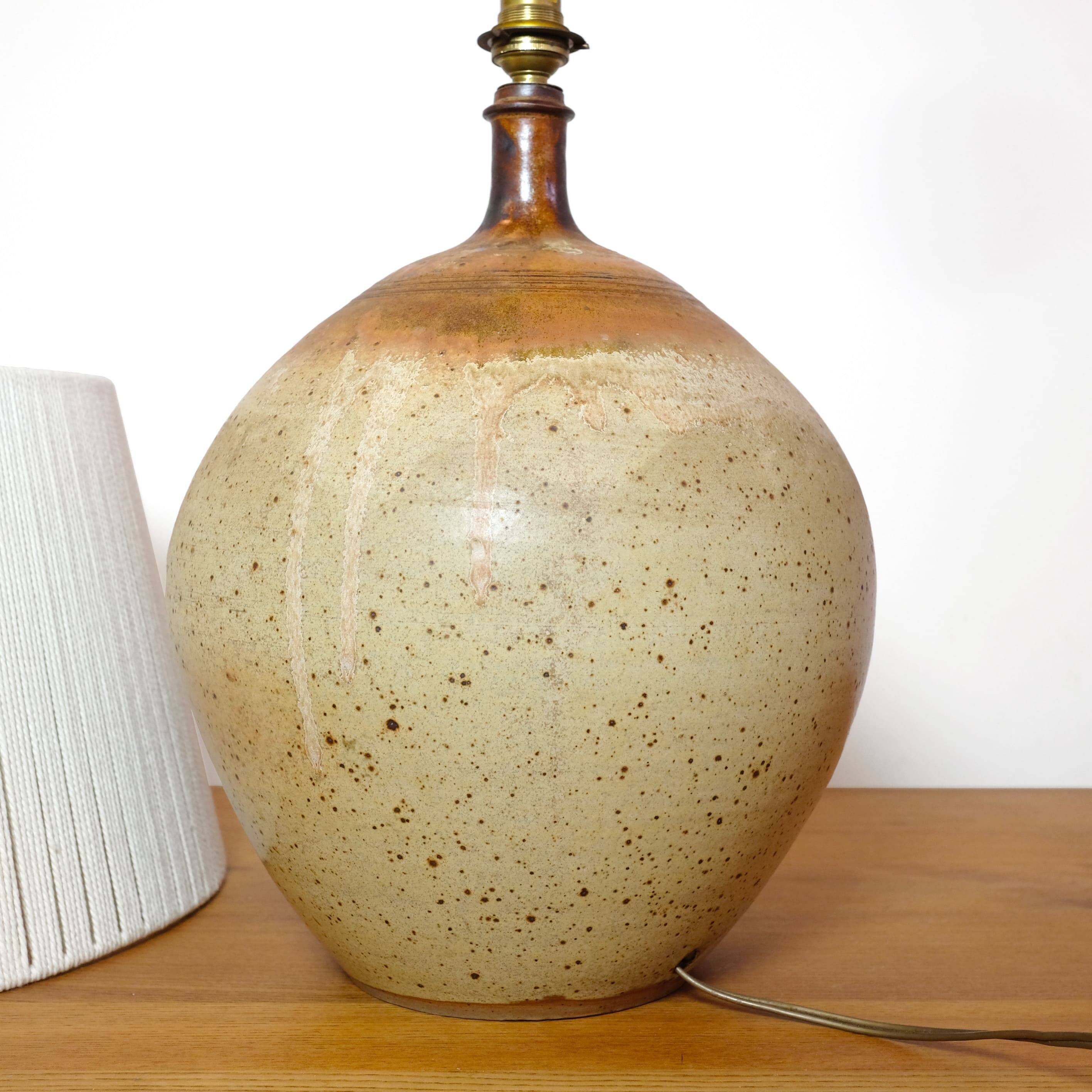 Large stone lamp with a cotton shade.