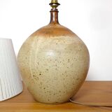 Large stone lamp with a cotton shade.