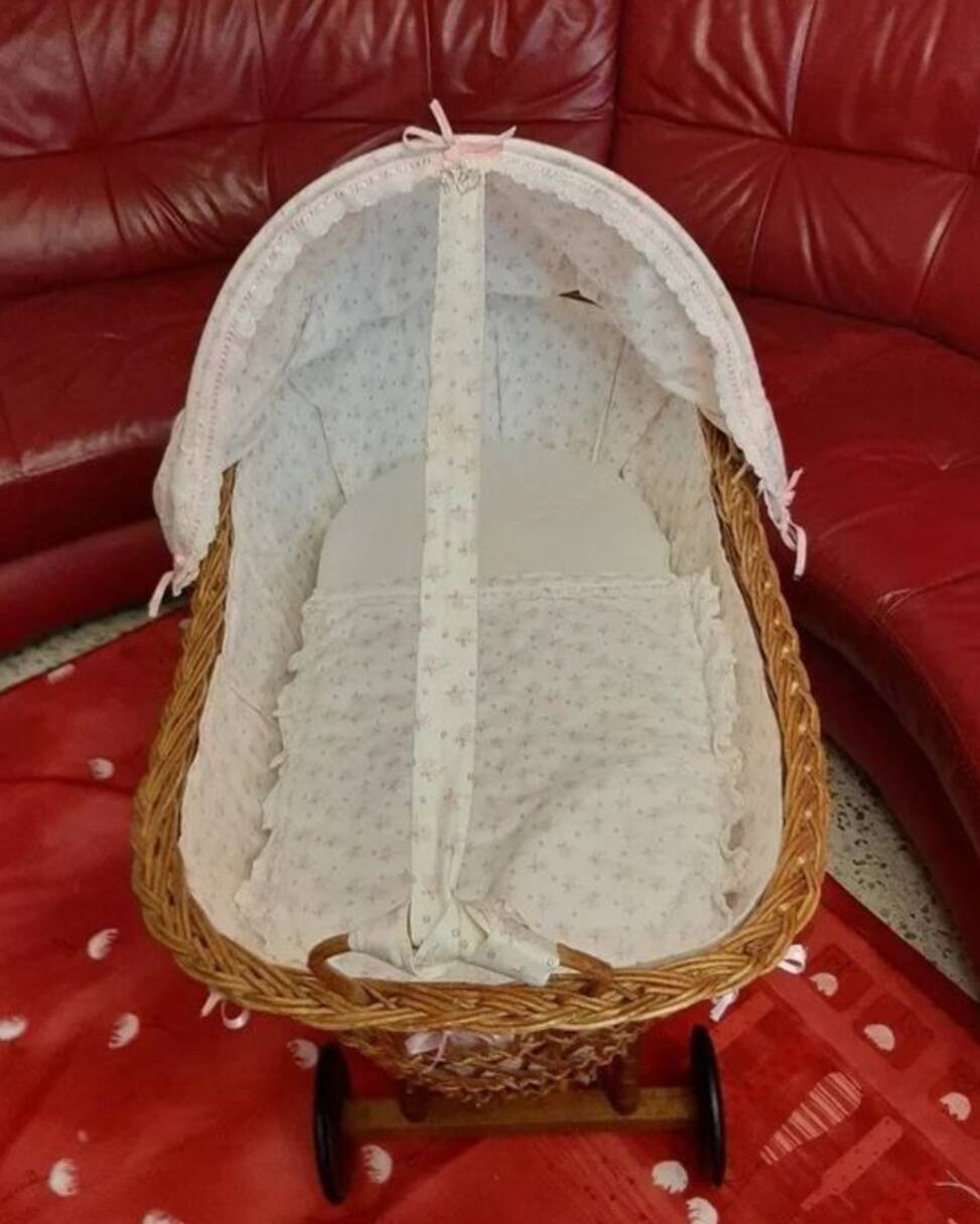 Vintage wicker cradle on wheels from the 1970s.