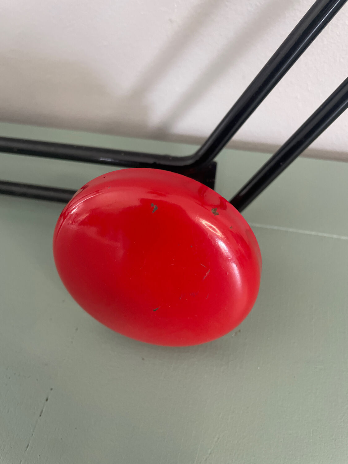 Coat rack, red and black metal hook.
