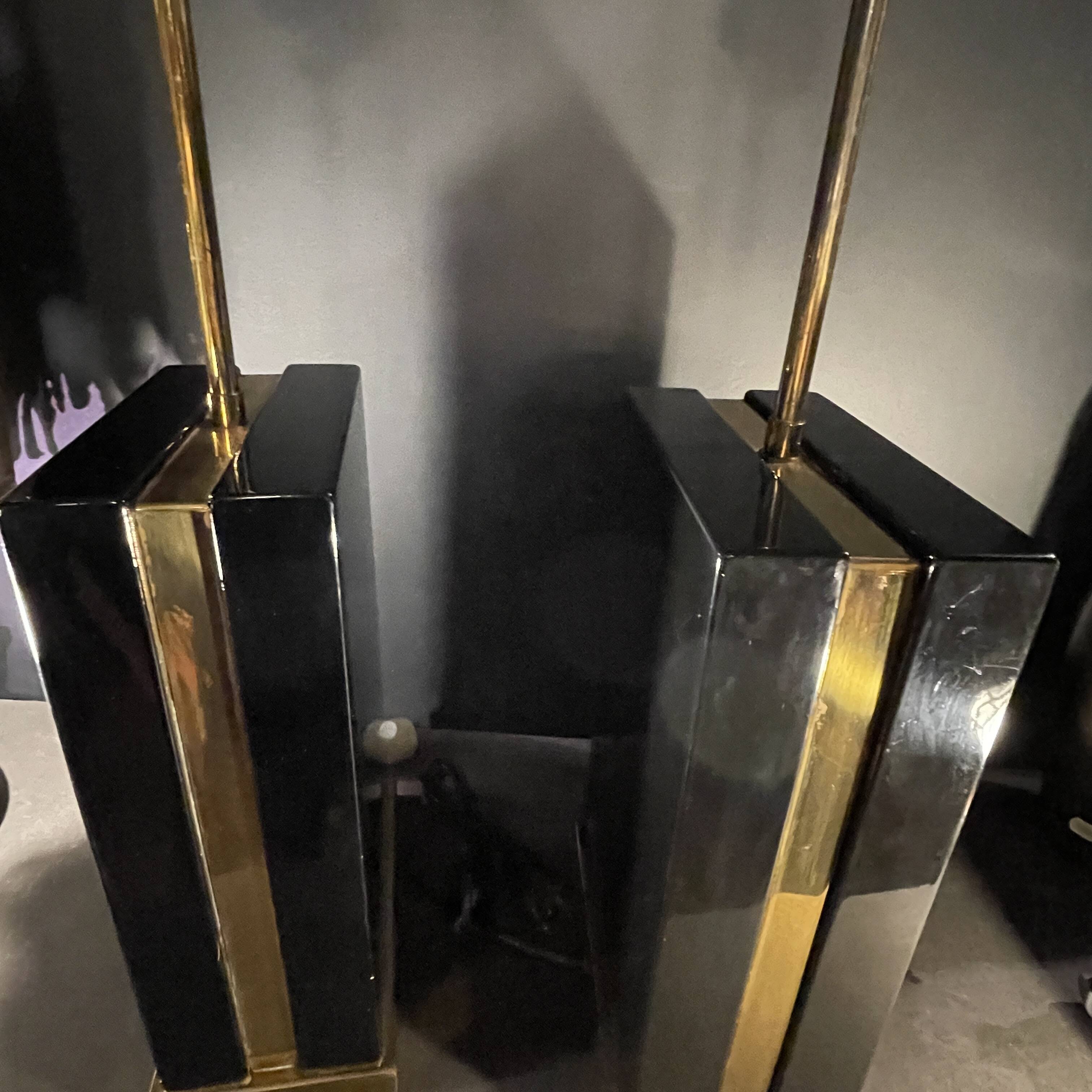 Pair of black lacquered and brass table lamps, circa 1970