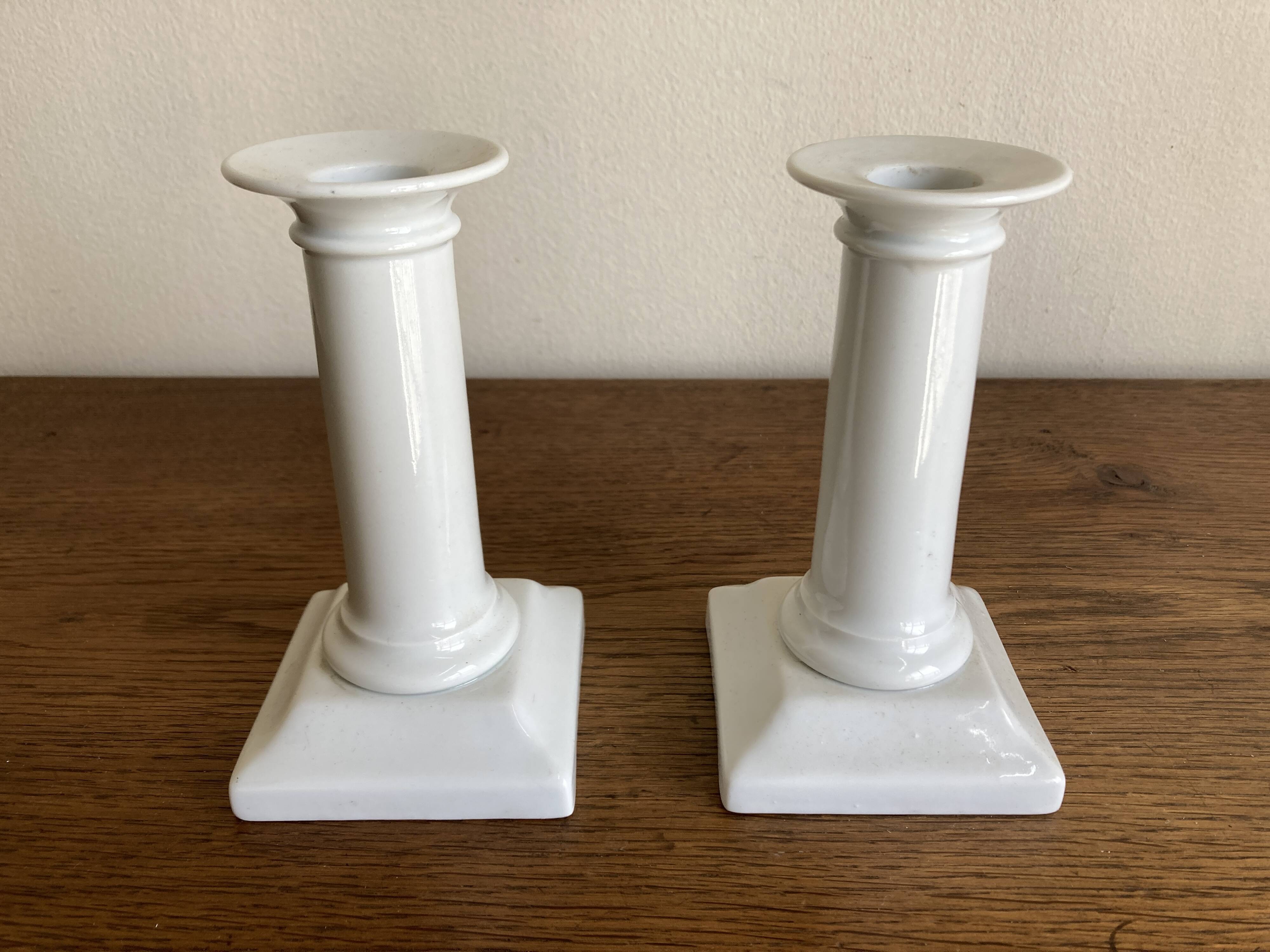 Pair of neo-classical Empire candlesticks from the late 19th century in white porcelain.