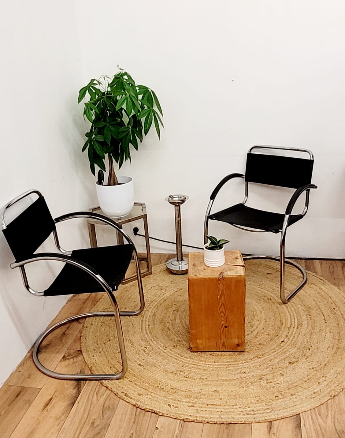 Three armchairs in black leather and steel tube