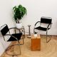 Three armchairs in black leather and steel tube