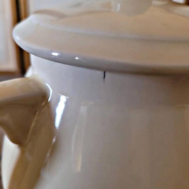 Vintage round ceramic teapot in cream colour, art deco style.