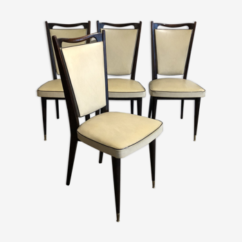 Four white leatherette chairs