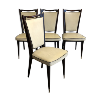 Four white leatherette chairs