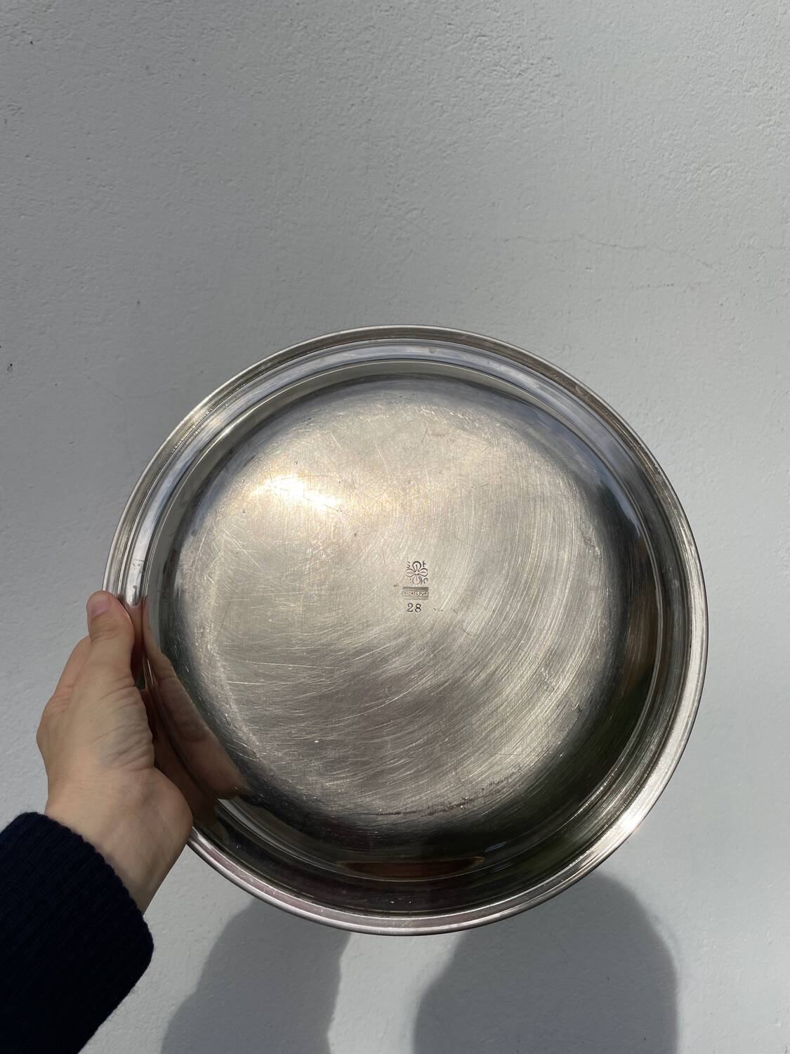 Round silver-plated metal serving dish with hallmark