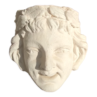 Old face in plaster antique decoration