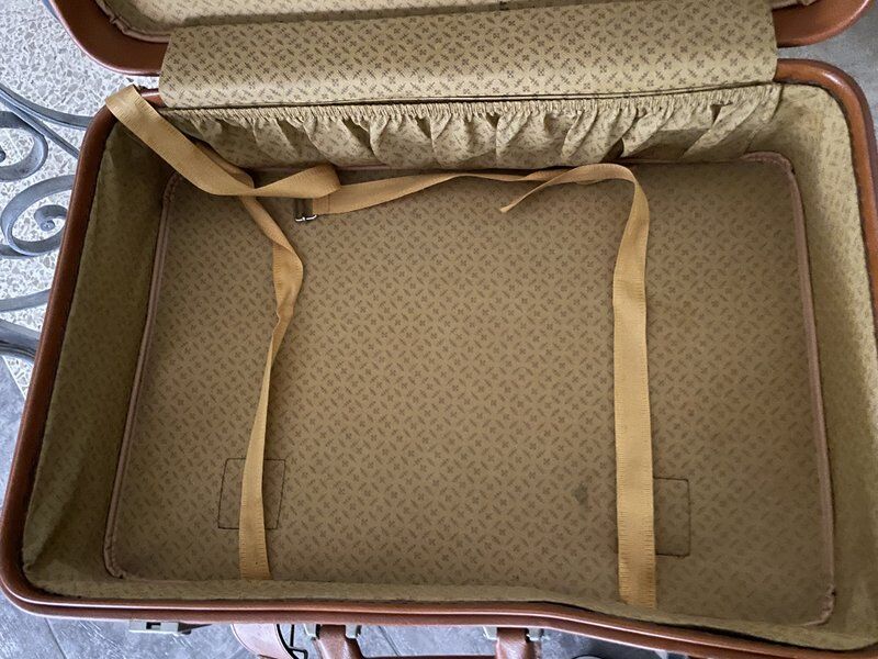 Antique suitcase with brown leather straps
