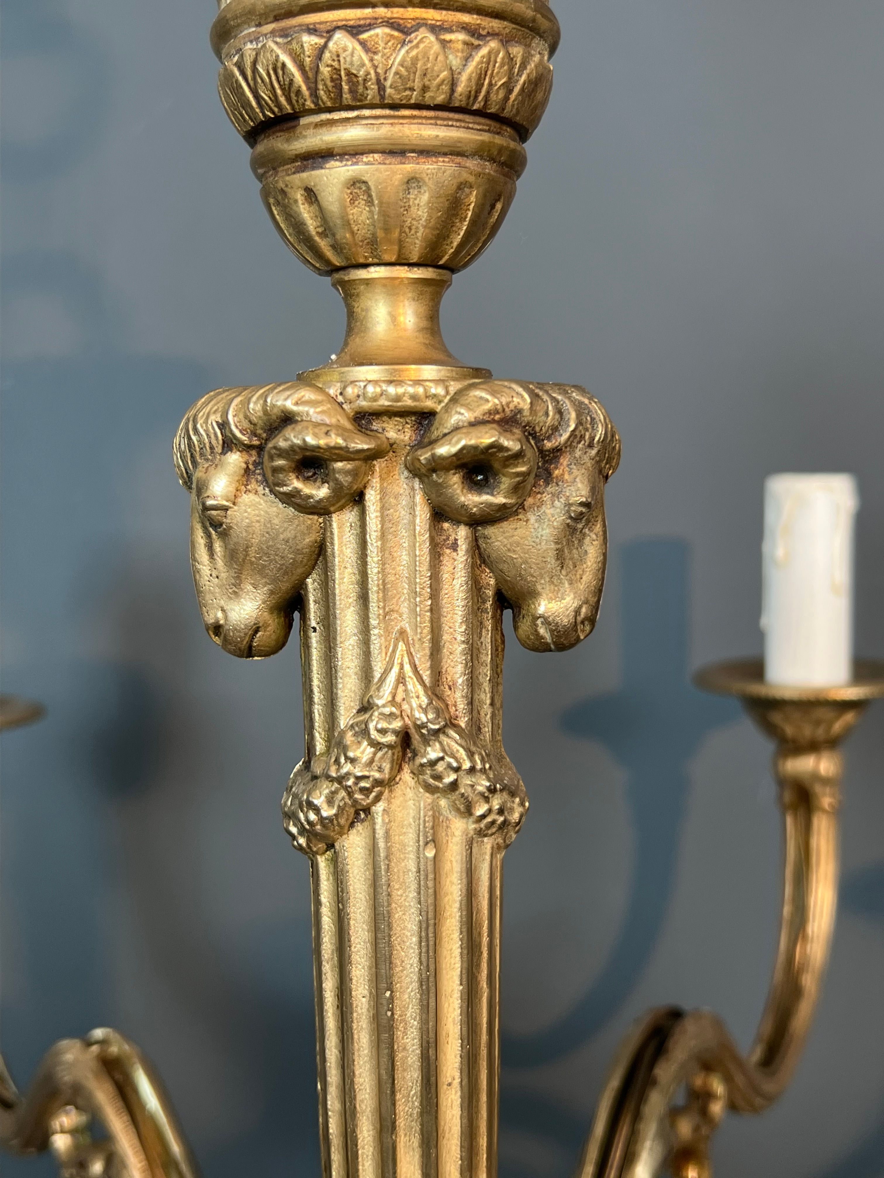 Bronze chandelier with ram's head motifs in the Louis XVI style, in the manner of Maison Jansen.