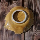 Empty yellow ceramic pocket in the shape of a leaf