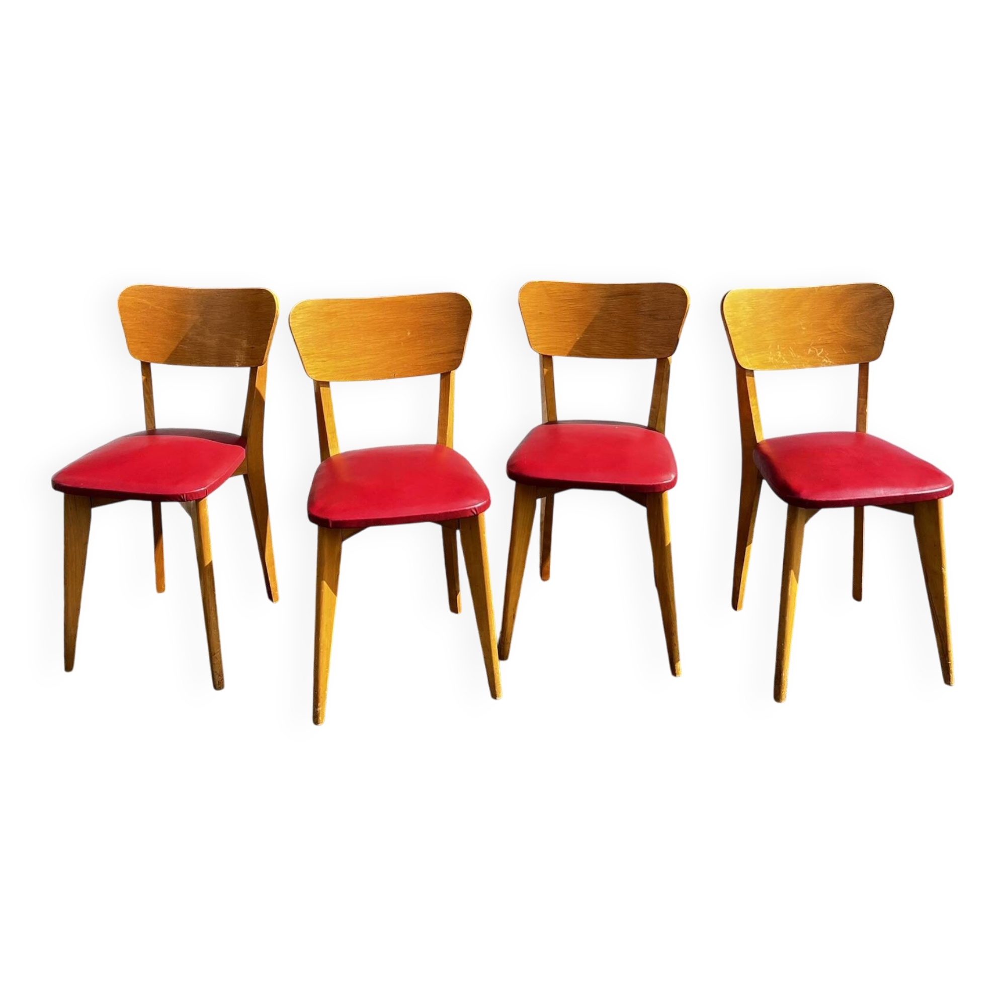 Set of 4 vintage bistro chairs in wood and red faux leather, with splayed legs.