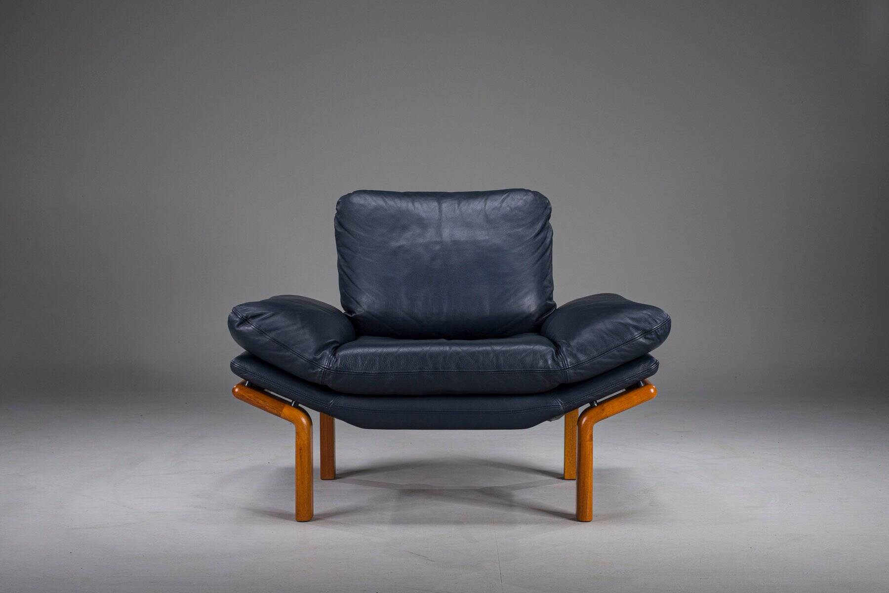 Danish teak and navy blue leather lounge chair from Komfort, 1970s