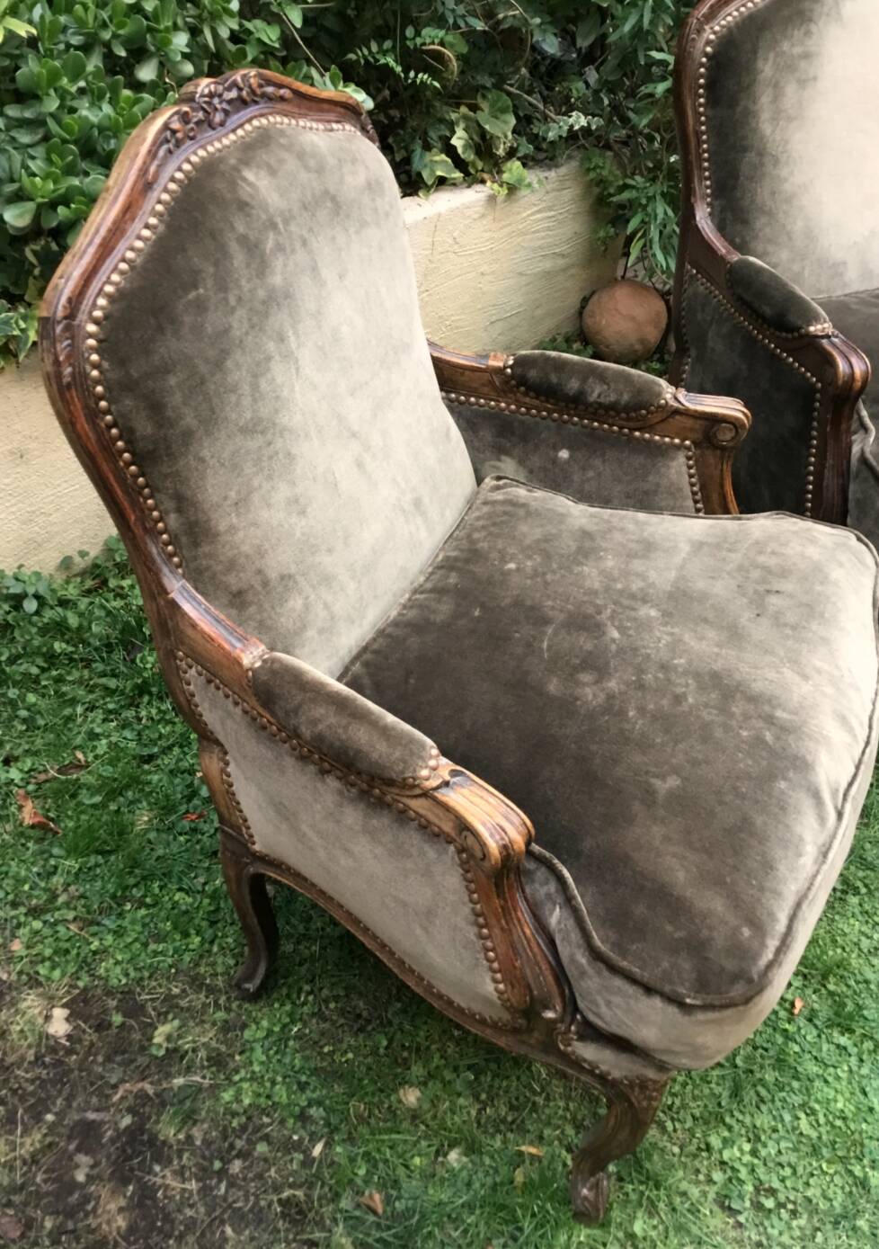 Pair of Louis XV style bergères in moulded and carved wood.