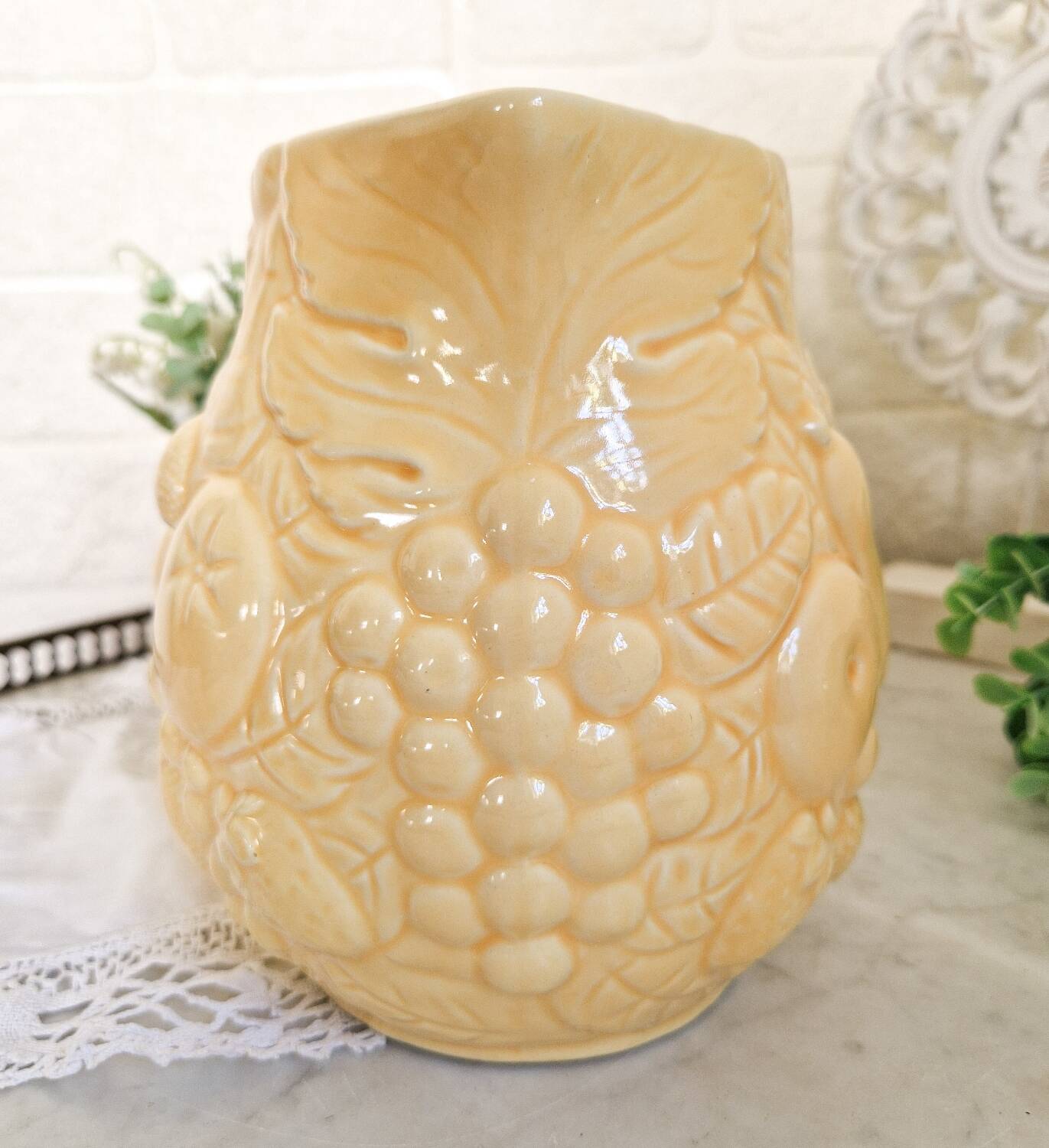 Vintage yellow pitcher in fruit slip