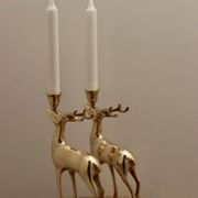 Pair of brass candle holders in the shape of deer from the mid-century.