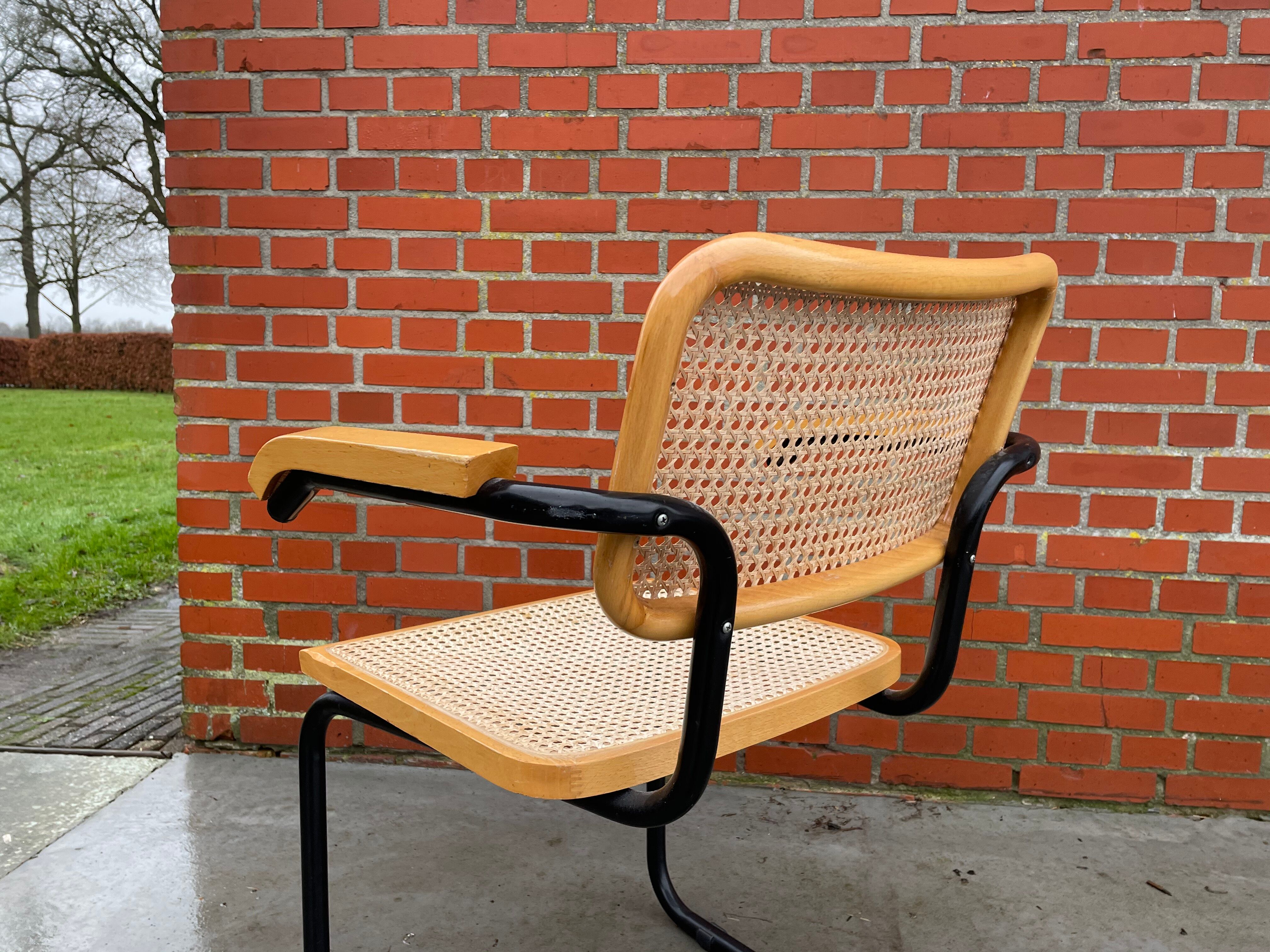Cesca model chair designed by Marcel Breuer with black-framed armrests