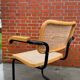 Cesca model chair designed by Marcel Breuer with black-framed armrests