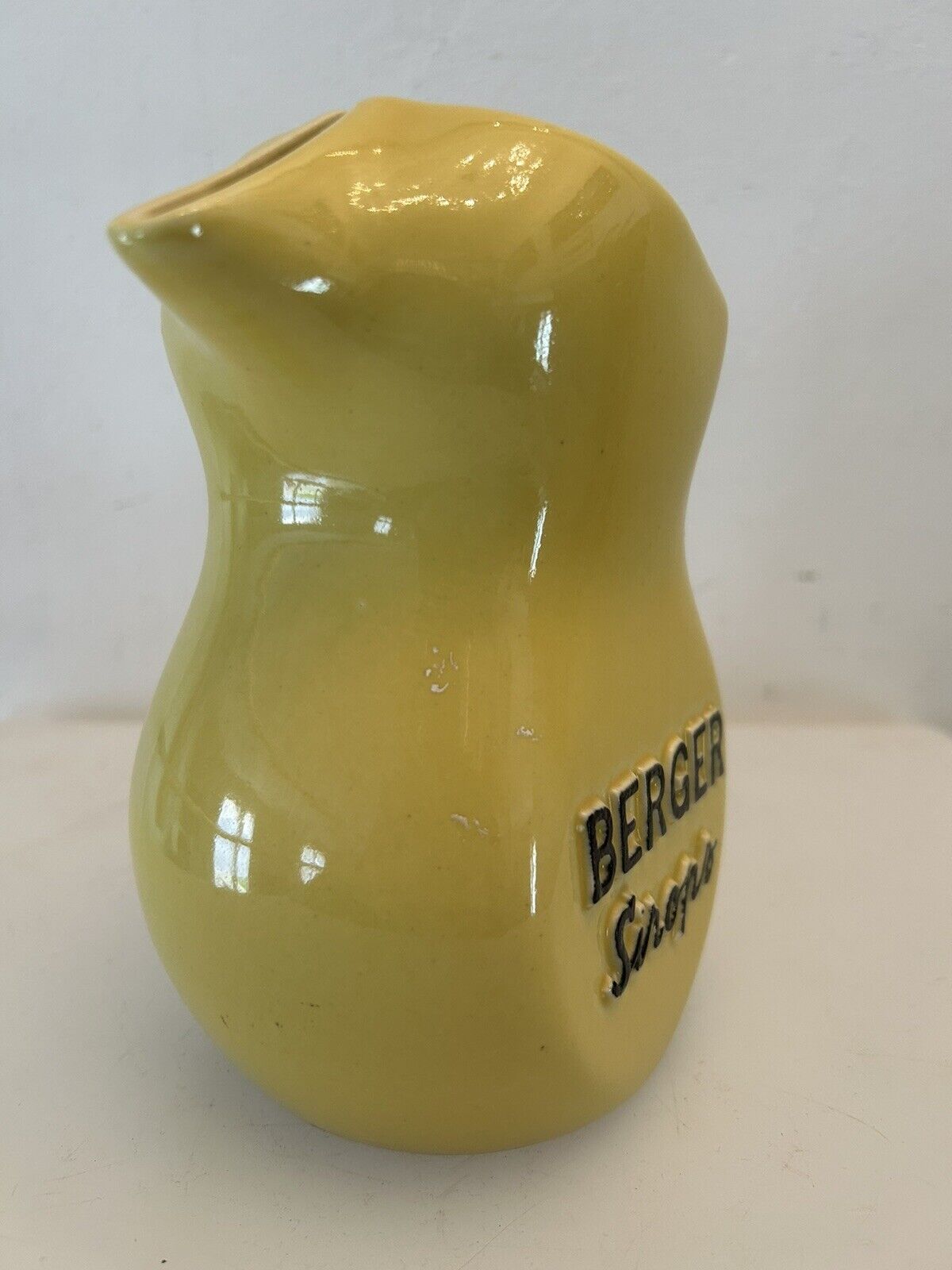 Old yellow pitcher anisette berger syrups, vintage bistro decoration