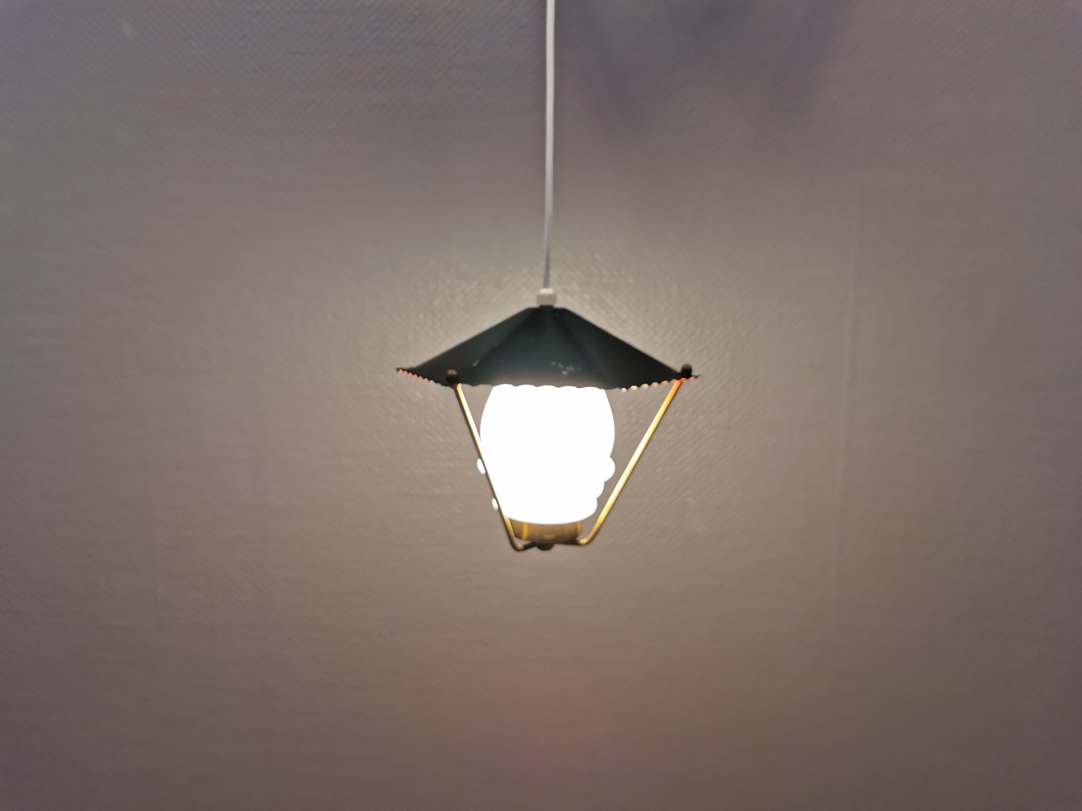 Danish hanging lamp from the 50-60s, made of brass, metal and with milky white glass shade.