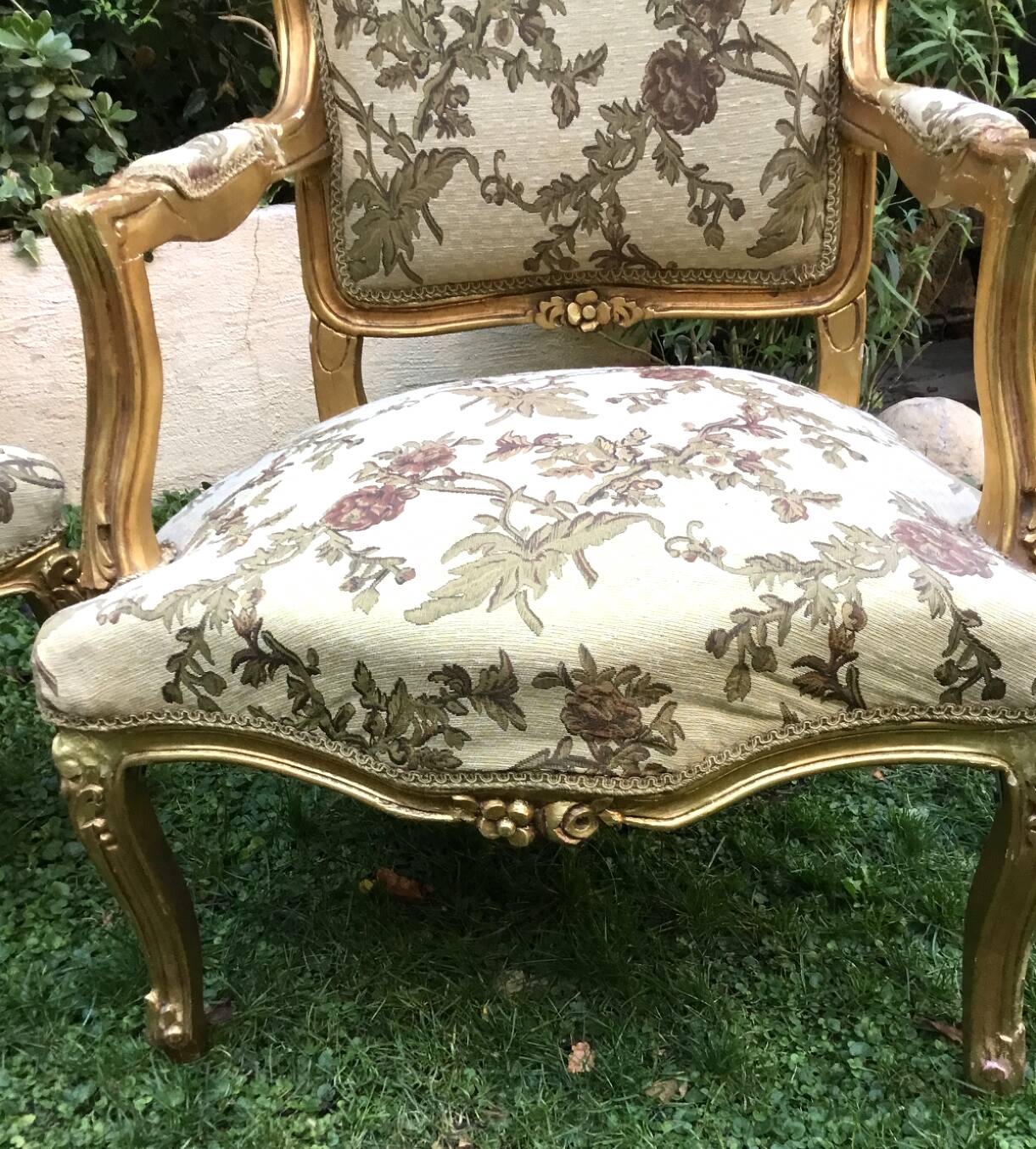 Pair of straight-backed armchairs, known as "queen's armchairs," in carved and gilded wood