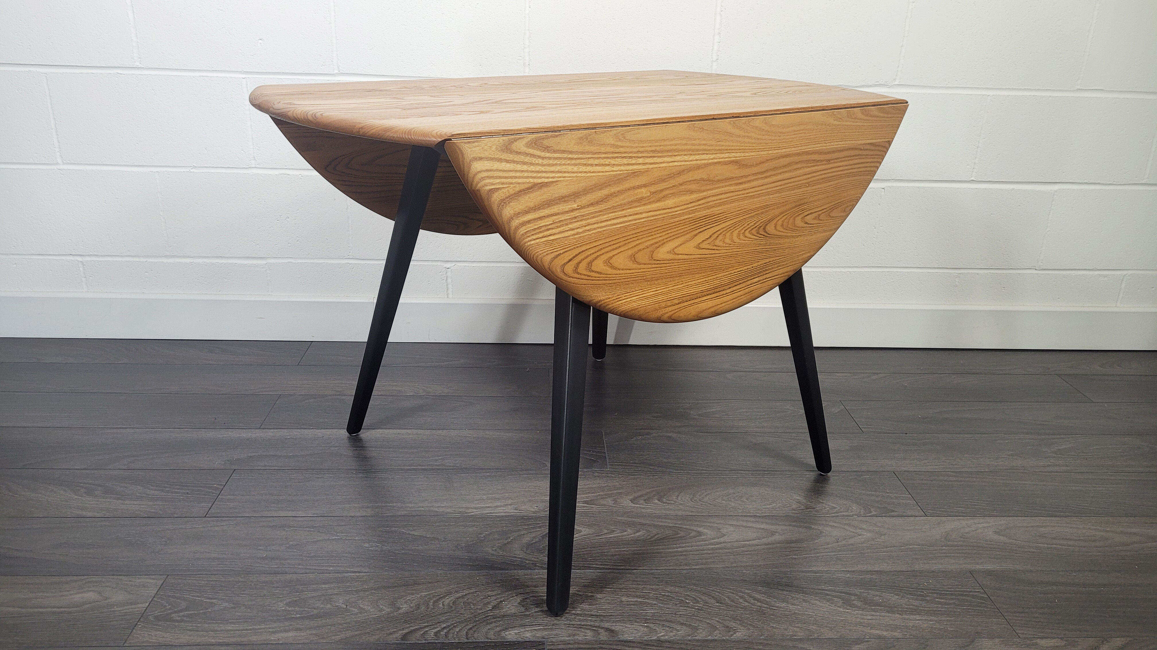 Ercol round drop leaf dining table - black leg, 1960